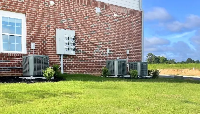 two hvac units outside a brick building